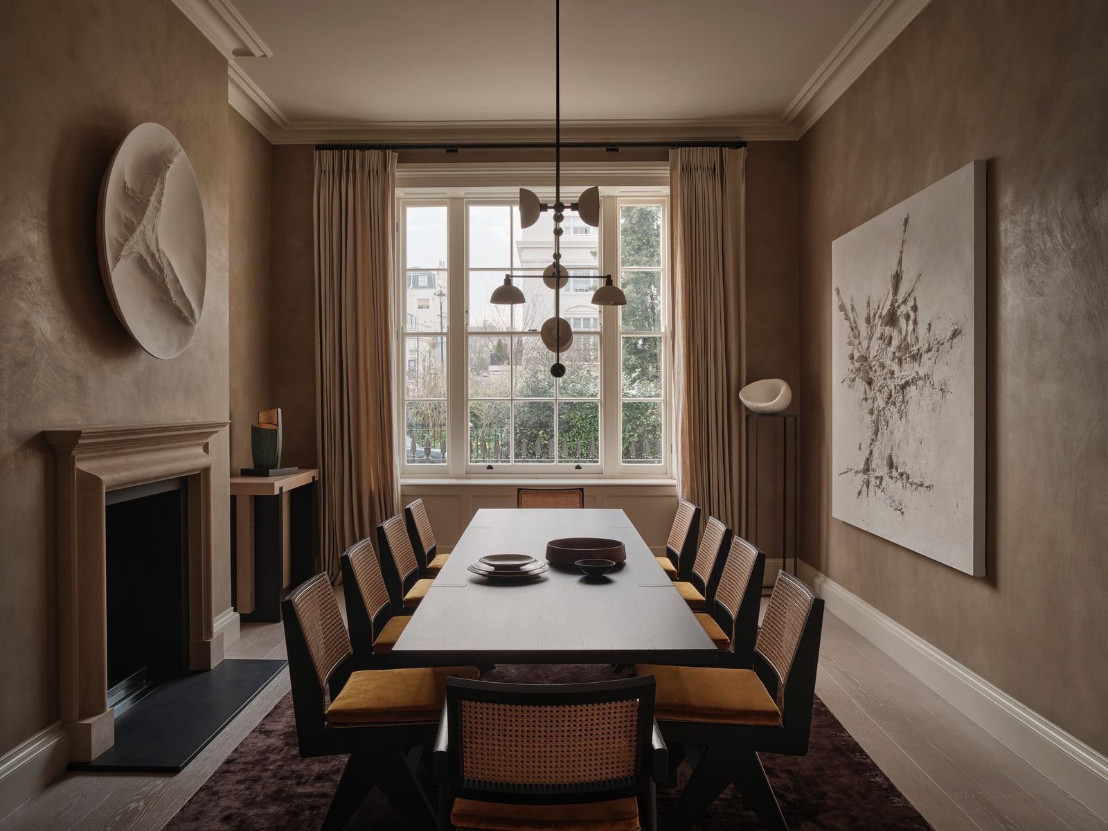 Belgravia townhouse dining room with artwork and sculptural furniture