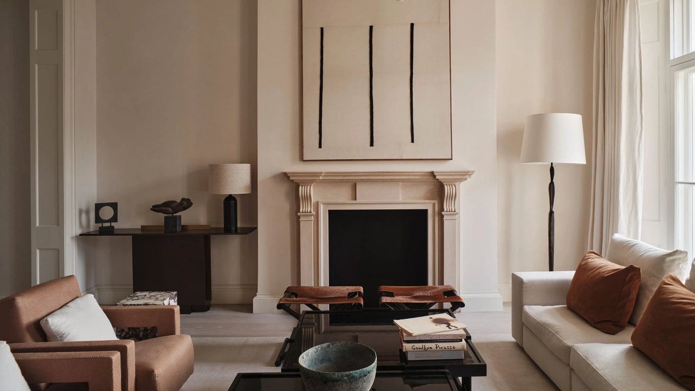 Living room with artwork, sculptural furniture and soft neutral textiles